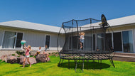 Load image into Gallery viewer, young girl jumping on the trampoline while other kids are watching her
