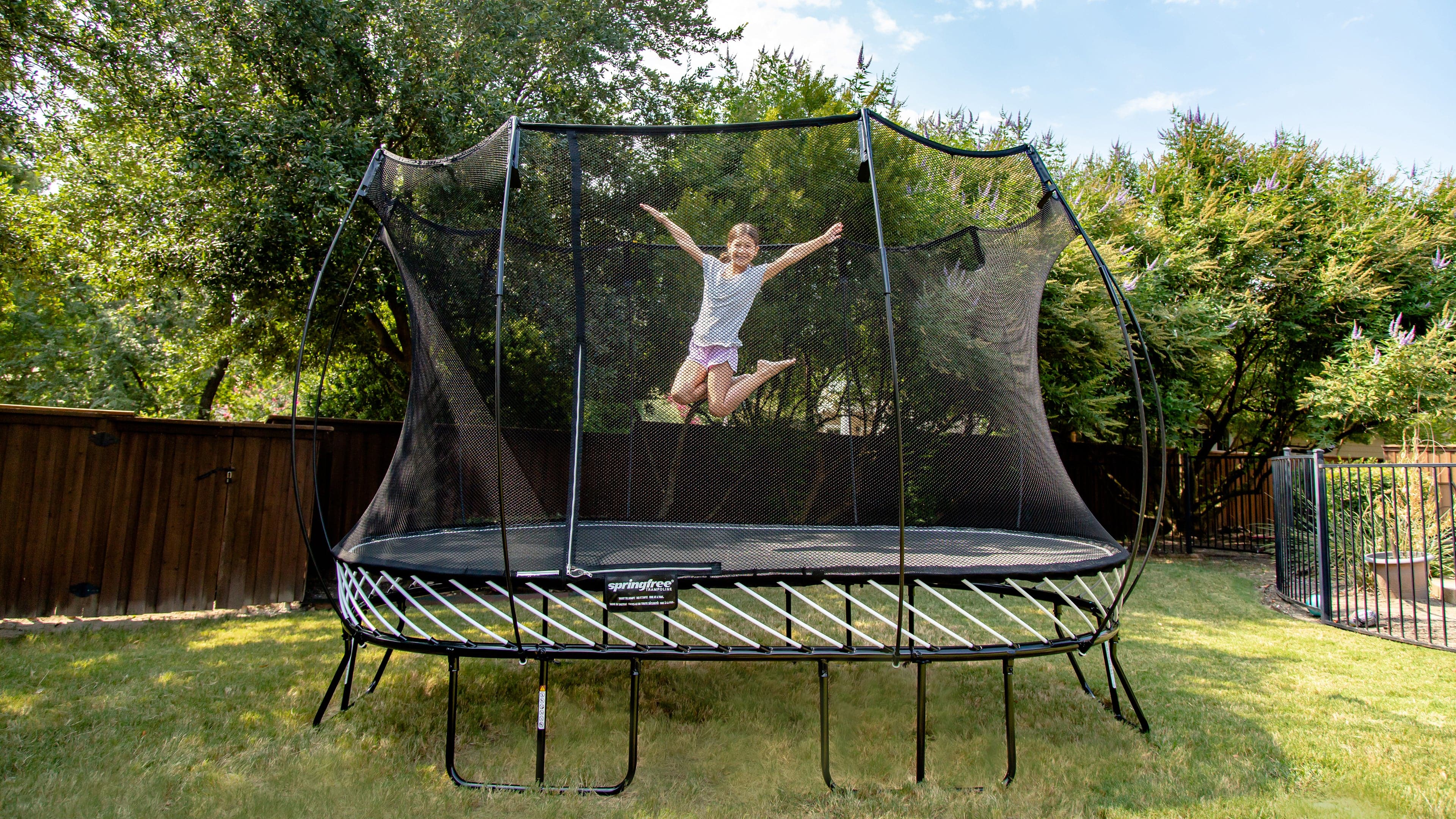 Girl jumping high on trampoline