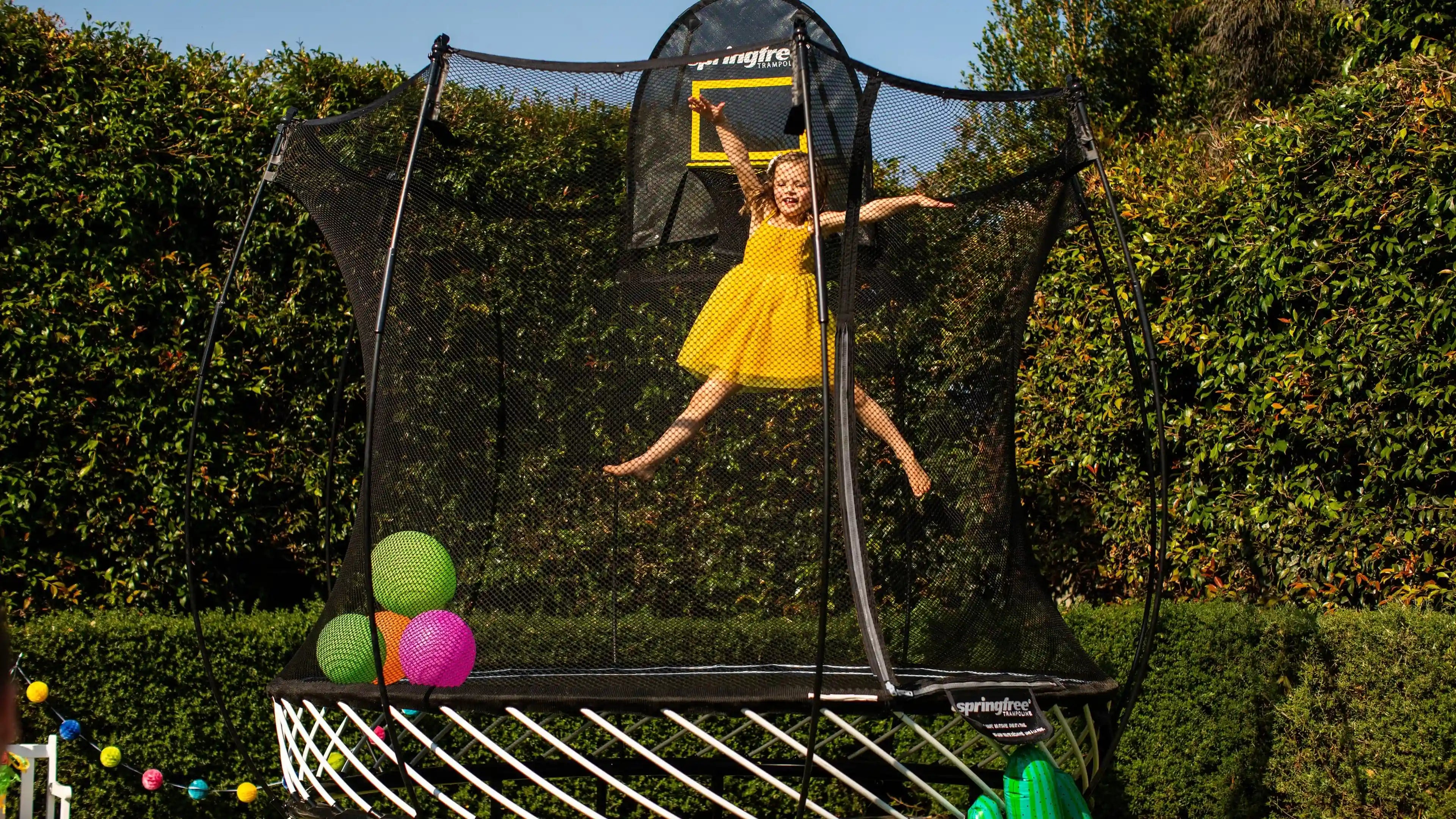 A girl jumping high on a trampoline