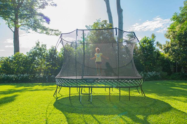 Girl jumping on outdoor trampoline