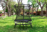 Load image into Gallery viewer, a young girl jumping high on a mini round trampoline