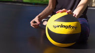 Load image into Gallery viewer, lady pumping a springfree trampoline ball