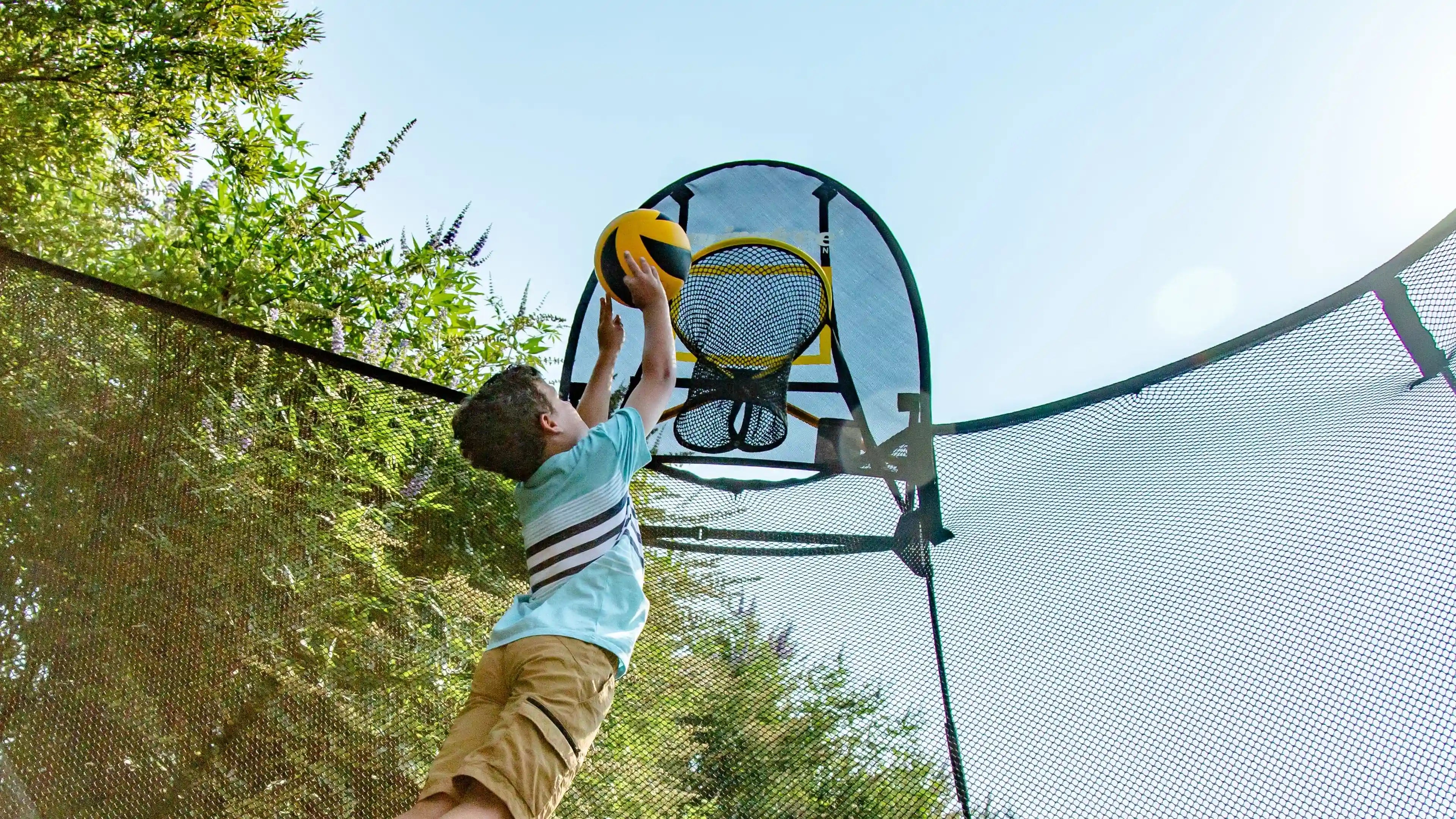 young boy playing basketball with a flexrhoop