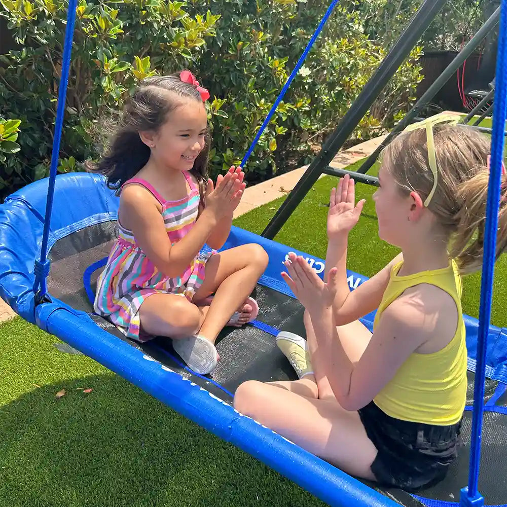 two girls playing on a double platform tree swing
