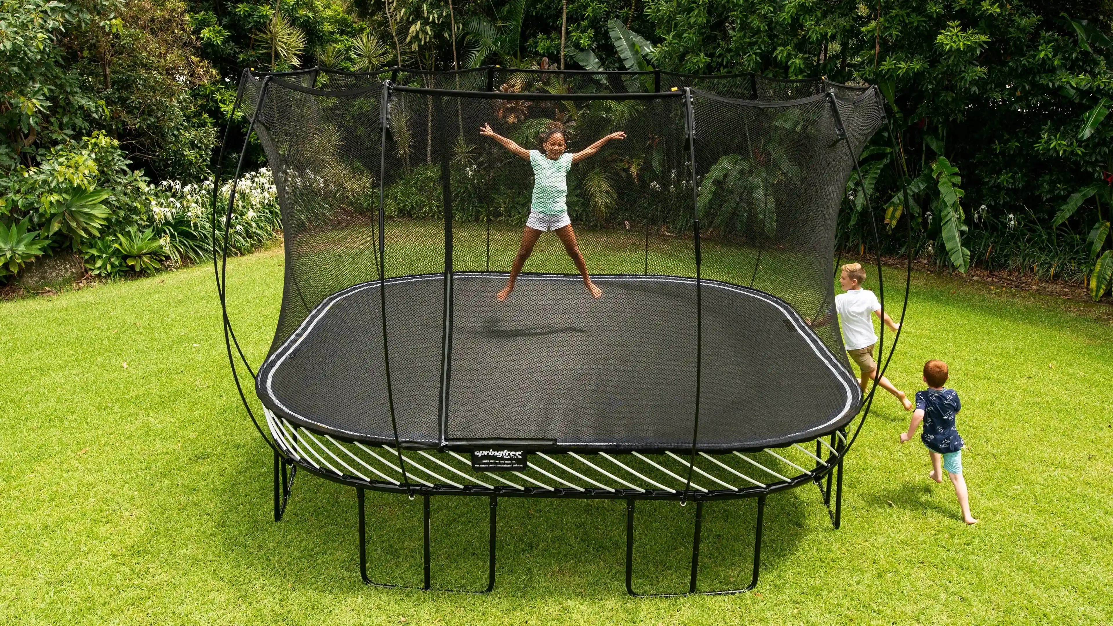 Kids playing around outdoor trampoline
