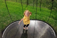 Load image into Gallery viewer, a young girl jumping on a trampoline
