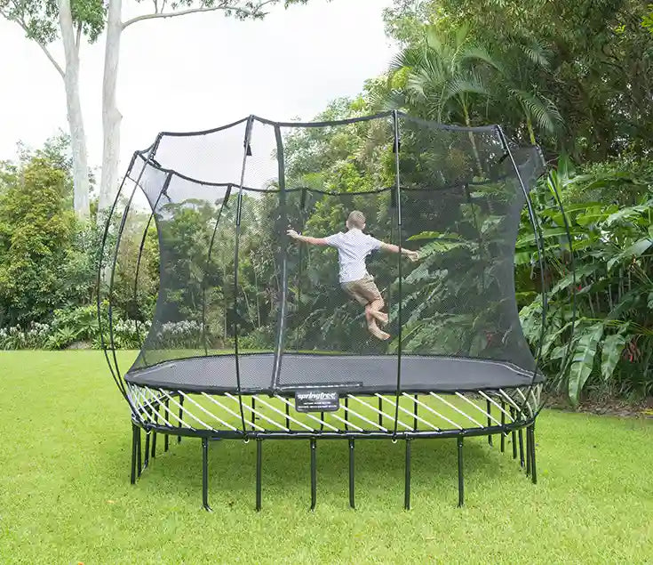 young boy jumping on an outdoor trampoline