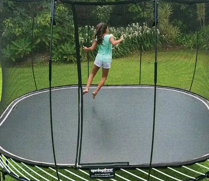 Young girl jumping on the trampoline
