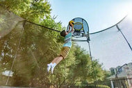 Load image into Gallery viewer, young boy playing basketball with a springfree trampoline ball
