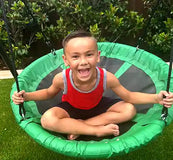 Load image into Gallery viewer, young boy sitting on a tree swing
